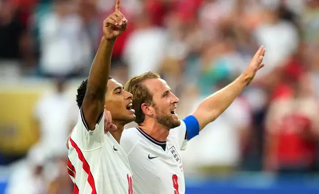 Jude Bellingham, left, and Harry Kane celebrates England's victory over Norway in a World Cup quarterfinal soccer match in Miami Gardens, Fla., Saturday, July 11, 2026. (AP Photo/Julio Cortez)