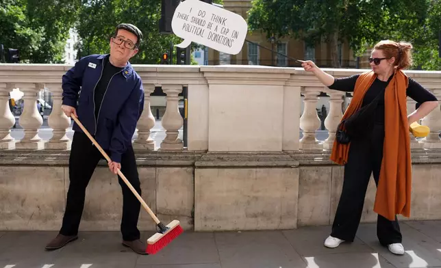 A protester wears a face mask mocking Andy Burnham outside Downing Street as Labour Party leader Andy Burnham is set to become the U.K.'s new prime minister on Monday, succeeding Keir Starmer in London, Monday, July 20, 2026. (AP Photo/Kin Cheung)