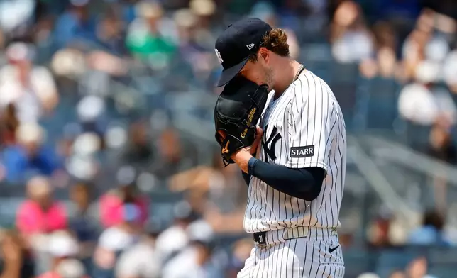 New York Yankees pitcher Cam Schlittler walks to the dugout during the fifth inning of the first game of a baseball doubleheader against the Los Angeles Dodgers, Sunday, July 19, 2026, in New York. (AP Photo/Noah K. Murray)