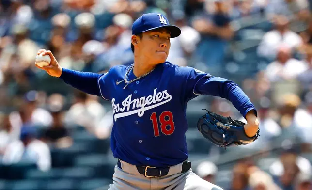 Los Angeles Dodgers' Yoshinobu Yamamoto delivers during the first inning of the first game of a baseball doubleheader against the New York Yankees, Sunday, July 19, 2026, in New York. (AP Photo/Noah K. Murray)
