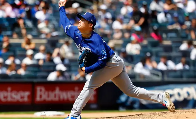 Los Angeles Dodgers' Yoshinobu Yamamoto throws against the New York Yankees during the sixth inning of the first game of a baseball doubleheader, Sunday, July 19, 2026, in New York. (AP Photo/Noah K. Murray)