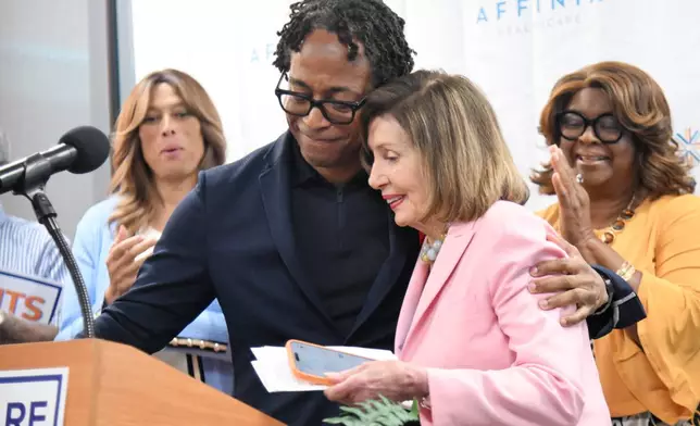 U.S. Rep. Wesley Bell, D-Mo., embraces U.S. Rep. Nancy Pelosi, D-Calif., at a healthcare rally hosted by Bell and Affinia Healthcare on Friday, July 24, 2026 in Ferguson, Mo. (AP Photo/Michael Thomas)