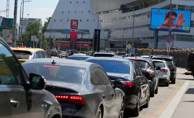 Cars line up at a Lukoil gas station in Moscow, Russia, Tuesday, June 30, 2026. (AP Photo/Alexander Zemlianichenko)
