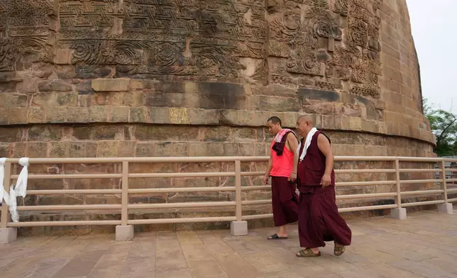 Buddhist monks circumambulate around Dhamek Stupa in the ancient Buddhist site of Sarnath, India, Saturday, July 18, 2026. (AP Photo/Rajesh Kumar Singh)