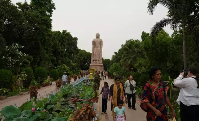 People visit the ancient Buddhist site of Sarnath, India, Saturday, July 18, 2026. (AP Photo/Rajesh Kumar Singh)