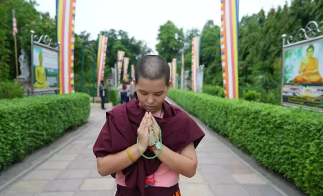 A devout Buddhist prays in the ancient Buddhist site of Sarnath, India, Saturday, July 18, 2026. (AP Photo/Rajesh Kumar Singh)