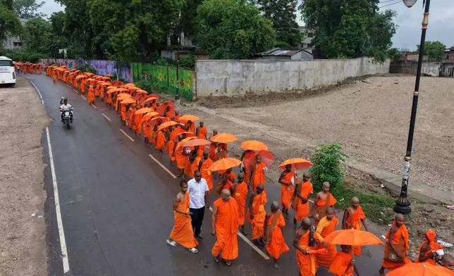 Novice monks walk in a procession in Sarnath, India, Sunday, July 19, 2026. (AP Photo/Rajesh Kumar Singh)