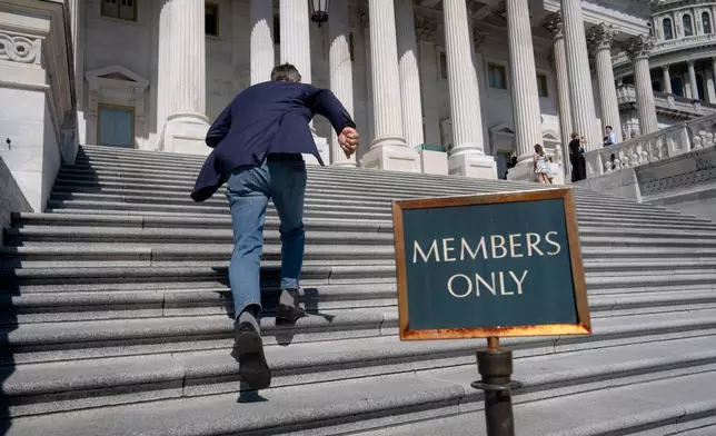 Rep. Darrell Issa, R-Calif., rushes up the steps at the Capitol for final votes before the House of Representatives leaves for a five-week recess, in Washington, Thursday, July 23, 2026. (AP Photo/J. Scott Applewhite)