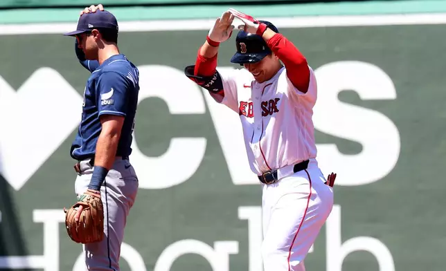 Boston Red Sox designated hitter Masataka Yoshida reacts after hitting a double during the second inning of the first baseball game of a doubleheader against the Tampa Bay Rays, Friday, July 17, 2026, in Boston. (AP Photo/Mark Stockwell)