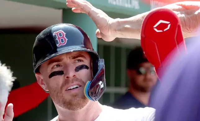 Boston Red Sox's Caleb Durbin reacts in the dugout after scroing a run during the sixth inning of the first baseball game of a doubleheader against the Tampa Bay Rays, Friday, July 17, 2026, in Boston. (AP Photo/Mark Stockwell)