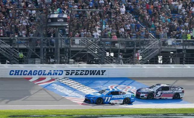 Denny Hamlin (11) and Kyle Larson (5) compete during a NASCAR Cup Series auto race at Chicagoland Speedway in Joliet, Ill., Sunday, July 5, 2026. (AP Photo/Nam Y. Huh)