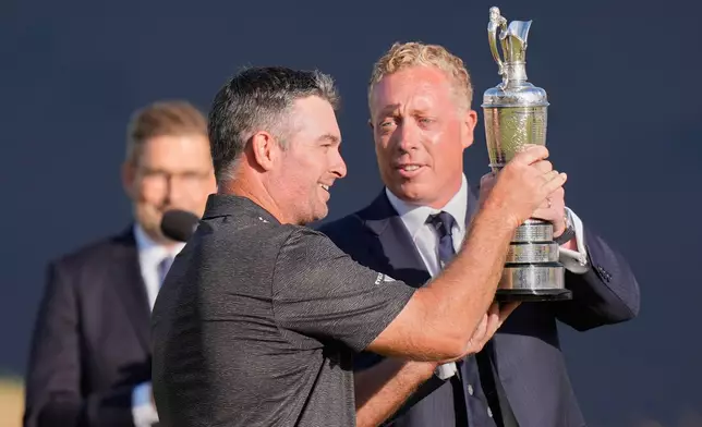 Ryan Fox of New Zealand, left, holds Claret Jug trophy after winning the British Open Golf championships at Royal Birkdale golf club, in Southport, England, Sunday, July 19, 2026. (AP Photo/David Goldman)