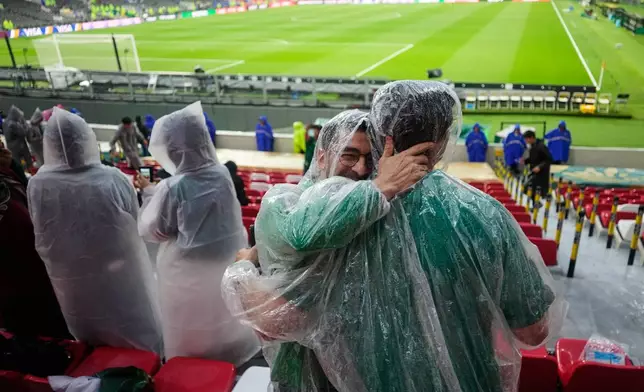 Fans wear ponchos as it rains ahead of the World Cup round of 32 soccer match between Mexico and Ecuador in Mexico City, Tuesday, June 30, 2026. (AP Photo/Ricardo Mazalan)
