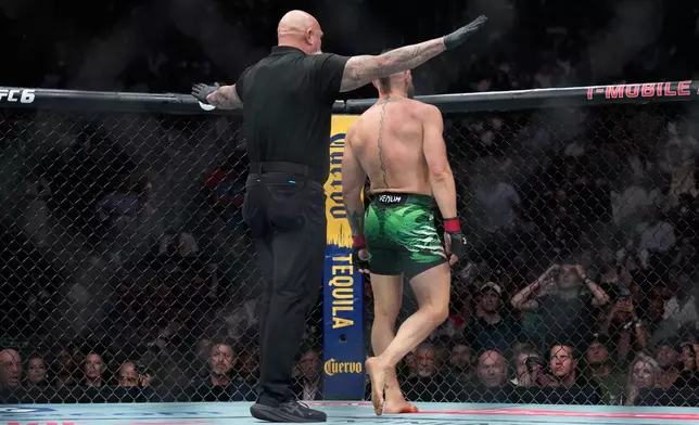 Conor McGregor reacts after he lost to Max Holloway in a welterweight fight at the UFC 329 mixed martial arts event Saturday, July 11, 2026, in Las Vegas. (AP Photo/John Locher)
