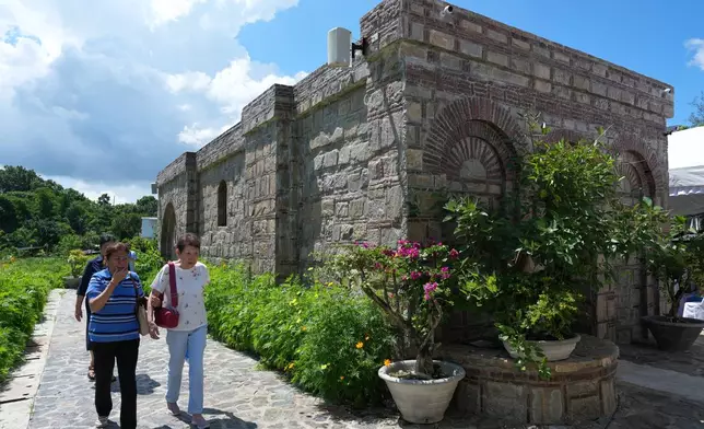Catholic devotees walk outside the Ephesus House, a replica of the House of the Virgin Mary in Ephesus, Turkey, at Alfonso town, Cavite province, Philippines, on July 16, 2026. (AP Photo/Aaron Favila)