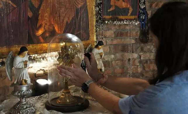 A devotee touches one of the relics of Mary inside the Ephesus House, a replica of the House of the Virgin Mary in Ephesus, Turkey, at Alfonso town, Cavite province, Philippines on July 16, 2026. (AP Photo/Aaron Favila)