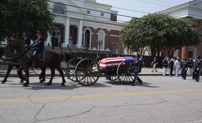 U.S. Sen. Lindsey Graham's casket on a horse-drawn caisson arrives at First Baptist Church in Columbia, S.C., on Wednesday, July 29, 2026. (AP Photo/Allen G. Breed)