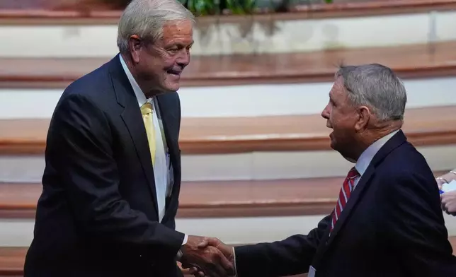 Rep. Ralph Norman, R-S.C., left, who is running to fill the seat of Sen. Lindsey Graham, R-S.C., greets an attendee before the late Sen. Graham's funeral at First Baptist Church in Columbia, S.C., Wednesday, July 29, 2026. (AP Photo/Gerald Herbert)
