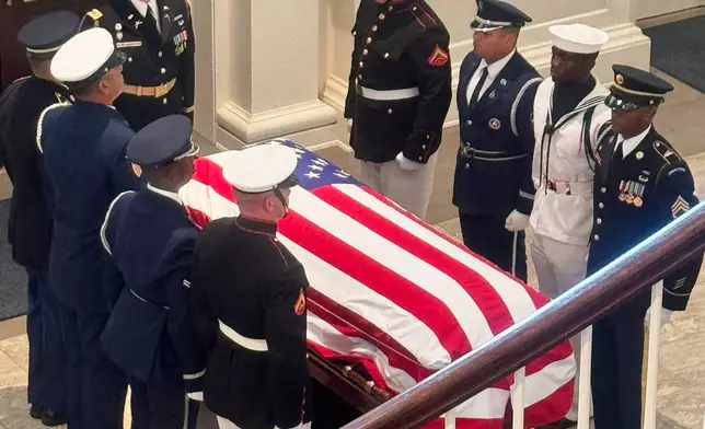 The casket of the late Sen. Lindsey Graham, R-S.C., is escorted into First Baptist Church in Columbia, S.C., for a funeral service Wednesday, July 29, 2026. (AP Photo/Meg Kinnard)