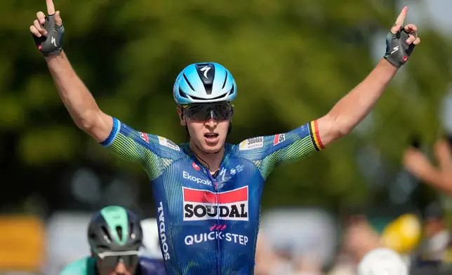 Belgium's Tim Merlier celebrates as he crosses the finish line to win the eighth stage of the Tour de France cycling race with start in Perigueux and finish in Bergerac, France, Saturday, July 11, 2026. (AP Photo/Mosa'ab Elshamy)