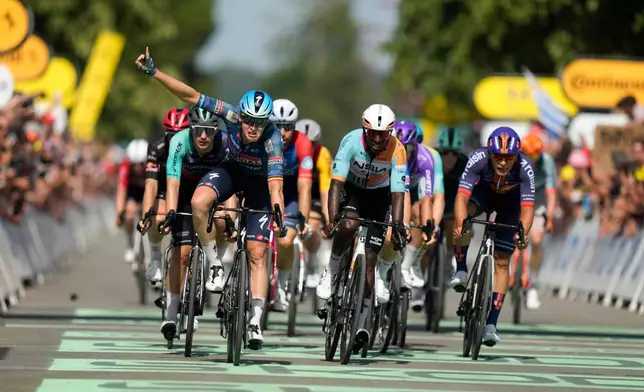 Belgium's Tim Merlier celebrates as he crosses the finish line to win the eighth stage of the Tour de France cycling race with start in Perigueux and finish in Bergerac, France, Saturday, July 11, 2026. (AP Photo/Mosa'ab Elshamy)