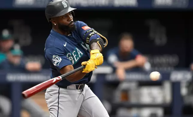 Seattle Mariners' Randy Arozarena hits a three-run home run during the fourth inning of a baseball game against the Tampa Bay Rays, Sunday, July 12, 2026, in St. Petersburg, Fla. (AP Photo/Phelan M. Ebenhack)
