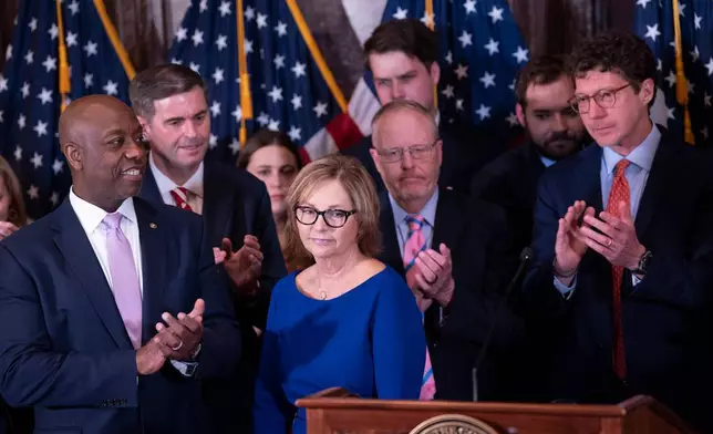 Newly appointed U.S. interim Senator Darline Graham Nordone, center, receives applause from Sen. Tim Scott (R-SC), left, and others at the conclusion of a news conference, Monday, July 13, 2026, in Columbia, S.C. (AP Photo/Sean Rayford)