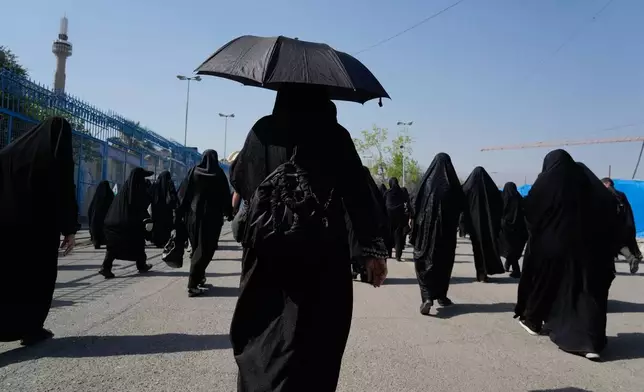 Mourners walk to a gathering commemorating the late Supreme Leader Ayatollah Ali Khamenei at the Imam Khomeini Mosalla Grand Mosque in Tehran, Tuesday, July 14, 2026. (AP Photo/Vahid Salemi)