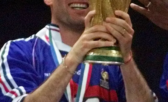 FILE - Zinedine Zidane of France displays the World Cup after the final of the soccer World Cup 98 between Brazil and France at the Stade de France in Saint Denis, north of Paris, Sunday, July 12, 1998. (AP Photo/Thomas Kienzle, file)