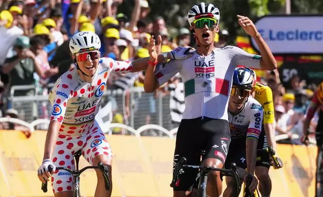 Slovenia's Tadej Pogacar, left, and Mexico's Isaac Del Toro celebrate as they cross the finish line of the second stage of the Tour de France cycling race with start in Tarragone and finish in Barcelona, Spain, Sunday, July 5, 2026. (AP Photo/Thibault Camus)