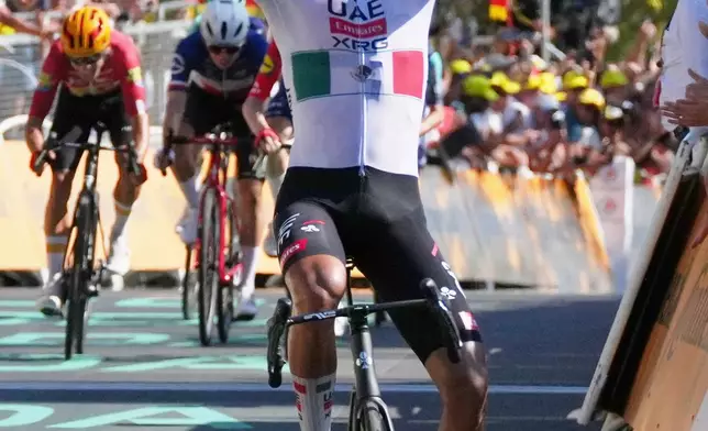 Mexico's Isaac Del Toro, celebrates as he crosses the finish line to win the second stage of the Tour de France cycling race with start in Tarragone and finish in Barcelona, Spain, Sunday, July 5, 2026. (AP Photo/Thibault Camus)