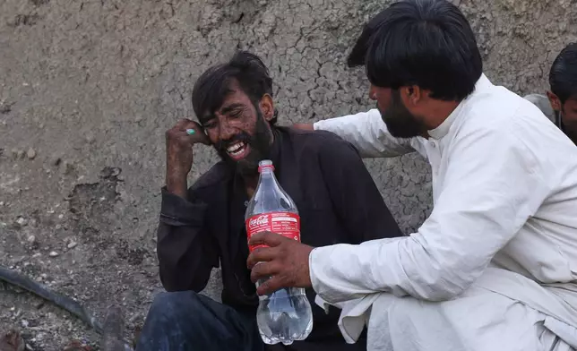 A man comforts a miner mourning fellow miners killed in an explosion at a coal mine on the outskirts of Quetta, in southwest Pakistan, Thursday, July 30, 2026. (AP Photo/Fazal Tawab)