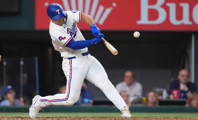 Texas Rangers' Wyatt Langford hits a runs scoring single in the ninth inning of a baseball game against the Los Angeles Angels, Thursday, July 9, 2026, in Arlington, Texas. (AP Photo/LM Otero)