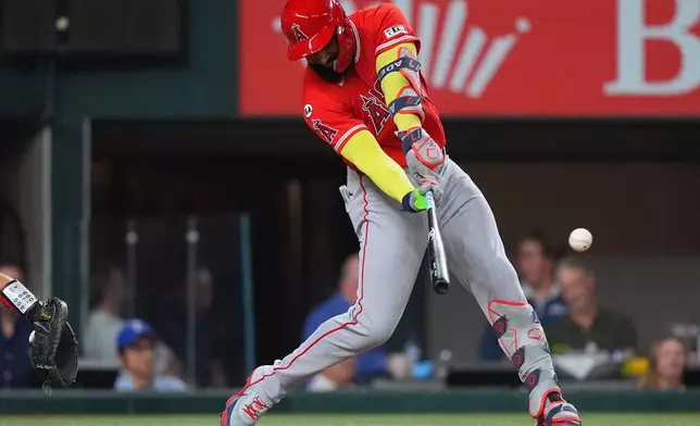 Los Angeles Angels' Jo Adell hits a run scoring single during the seventh inning of a baseball game against the Texas Rangers, Thursday, July 9, 2026, in Arlington, Texas. (AP Photo/LM Otero)