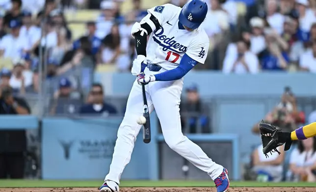 Los Angeles Dodgers' Shohei Ohtani hits a home run during the first inning of a baseball game against the Arizona Diamondbacks, Friday, July 10, 2026, in Los Angeles. (AP Photo/William Liang)