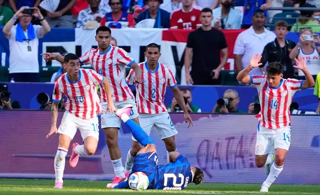 Paraguay's Miguel Almiron (10) controls the ball as France's Desire Doue falls during the World Cup round of 16 soccer match in Philadelphia, Saturday, July 4, 2026. (AP Photo/Petr David Josek)