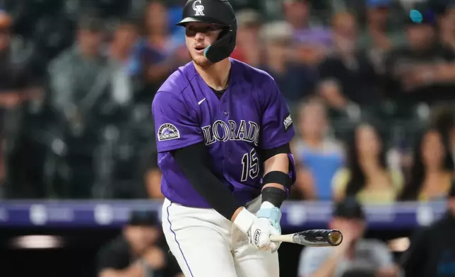 Colorado Rockies' Hunter Goodman reacts after striking out against Miami Marlins relief pitcher Pete Fairbanks in the ninth inning of a baseball game Monday, June 29, 2026, in Denver. (AP Photo/David Zalubowski)