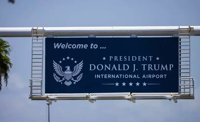A sign displaying the name of the rebranded Donald J. Trump International Airport in West Palm Beach, Fla., is seen Thursday, July 9, 2026. (AP Photo/Saul Martinez)