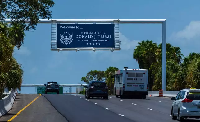 Airport visitors drive under a sign displaying the name of the rebranded Donald J. Trump International Airport in West Palm Beach, Fla., Thursday, July 9, 2026. (AP Photo/Saul Martinez)