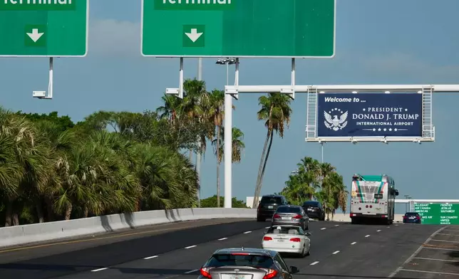 Airport visitors drive under a sign displaying the name of the rebranded Donald J. Trump International Airport in West Palm Beach, Fla., Thursday, July 9, 2026. (AP Photo/Cody Jackson)