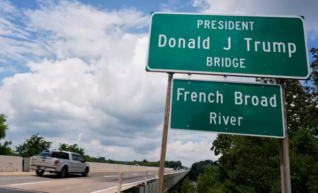 The sign for the newly renamed President Donald J. Trump bridge is posted along side the roadway Thursday, July 9, 2026, in Dandridge, Tenn. (AP Photo/George Walker IV)