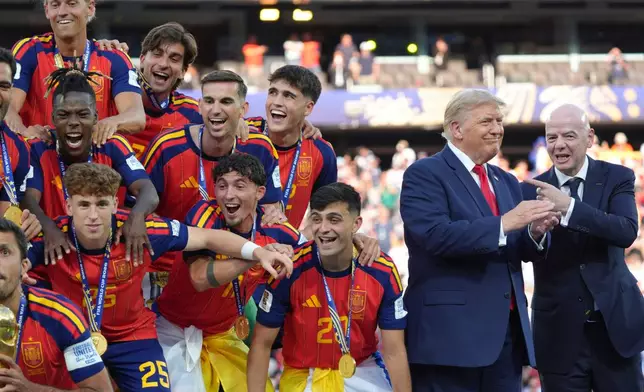 Spain players, from left, cheer alongside President Donald Trump and FIFA President Gianni Infantino at the conclusion of the World Cup championship final soccer match between Spain and Argentina in East Rutherford, N.J., Sunday, July 19, 2026. (AP Photo/Jacquelyn Martin)
