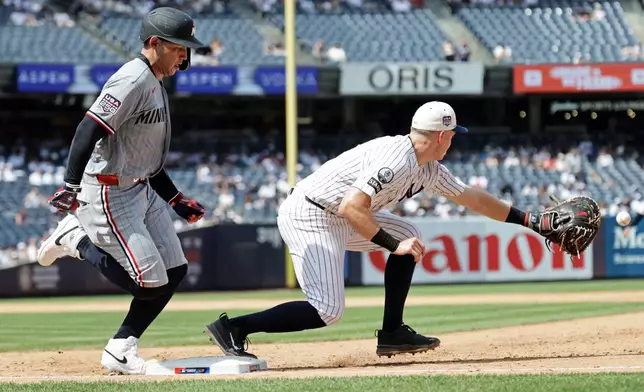 Minnesota Twins' Alex Jackson, left, is safe at first ahead of a throw to New York Yankees first baseman Ben Rice during the sixth inning of a baseball game Saturday, July 4, 2026, in New York. (AP Photo/Adam Hunger)