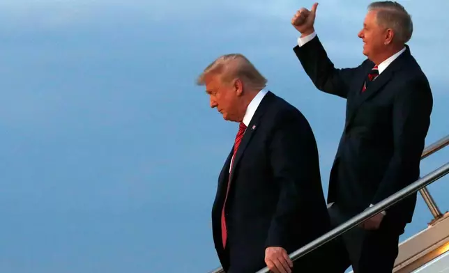 FILE - President Donald Trump, left, exits Air Force One with Sen. Lindsey Graham, R-S.C., Feb. 28, 2020, on arrival to North Charleston, S.C., where he will attend a campaign rally. (AP Photo/Jacquelyn Martin, File)