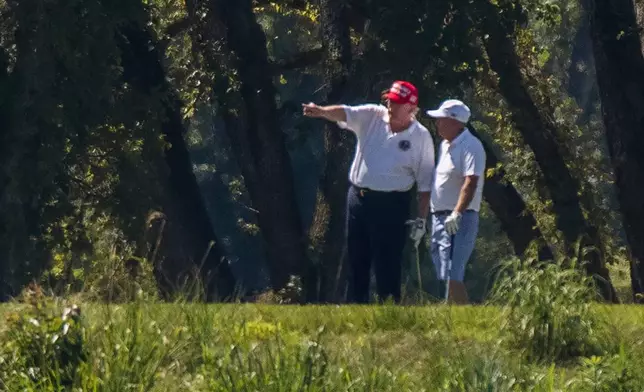 FILE - President Donald Trump and Sen. Lindsey Graham, R-S.C., right, play golf at Trump National Golf Club in Sterling, Va., as seen from the other side of the Potomac River in Darnestown, Md., July 18, 2020. (AP Photo/Manuel Balce Ceneta, File)