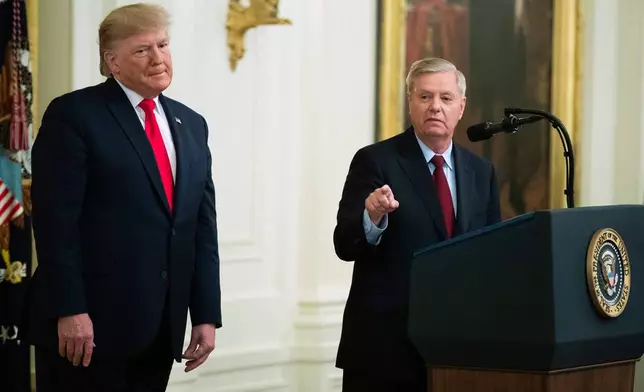 FILE - President Donald Trump listens to Sen. Lindsey Graham, R-S.C., speak during a ceremony in the East Room of the White House, Nov. 6, 2019, in Washington. (AP Photo/Manuel Balce Ceneta, File)