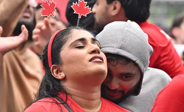 Fans at FIFA Fan Fest react as Morocco defeats Canada to advance during the second half of their World Cup soccer match in Toronto on Saturday, July 4, 2026. (Jon Blacker/The Canadian Press via AP)