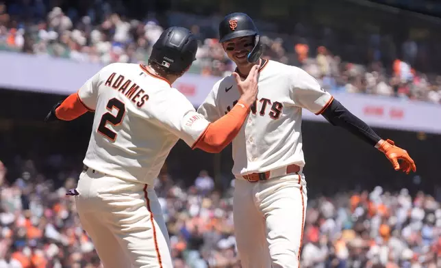 San Francisco Giants' Daniel Susac, right, celebrates after hitting a three-run home run that also scored Willy Adames (2) and Jung Hoo Lee during the second inning of a baseball game against the Milwaukee Brewers, Wednesday, July 29, 2026, in San Francisco. (AP Photo/Jeff Chiu)