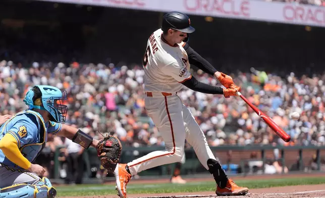 San Francisco Giants' Daniel Susac, right, hits a three-run home run next to Milwaukee Brewers catcher Gary Sánchez during the second inning of a baseball game, Wednesday, July 29, 2026, in San Francisco. (AP Photo/Jeff Chiu)