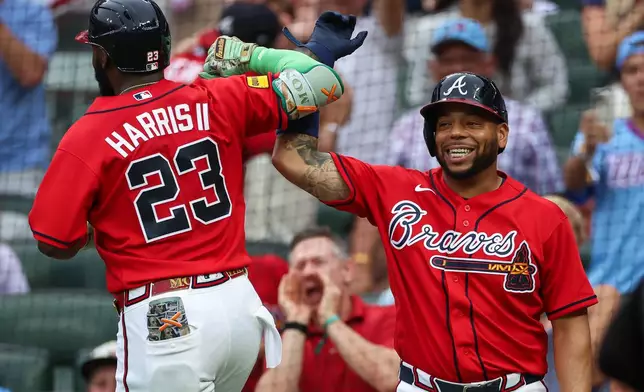 Atlanta Braves' Michael Harris II (23) reacts with Dominic Smith, right, after hitting a two-run home run in the second inning of a baseball game against the New York Mets, Friday, July 3, 2026, in Atlanta. (AP Photo/Colin Hubbard)